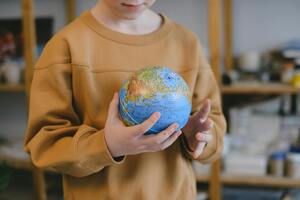 boy holding a globe